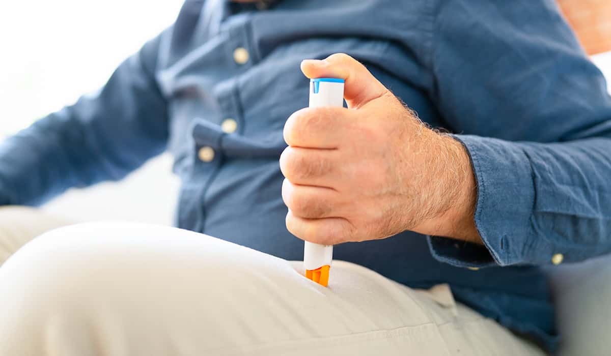 An image of someone using an epi pen