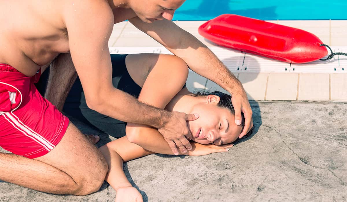 An image of a lifeguard using the recovery position