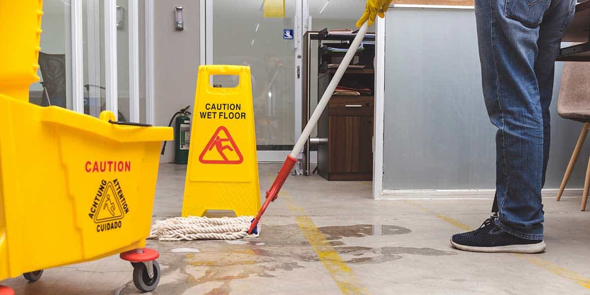 A janitor mops up the floor of a school
