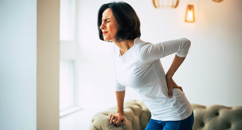 An older woman experiences lower back pain