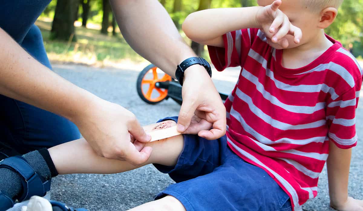 Putting a plaster on a child's knee