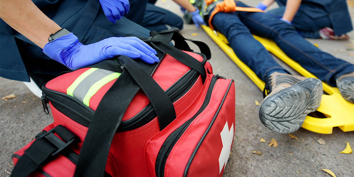 Trauma first aid kit being used to treat an injury