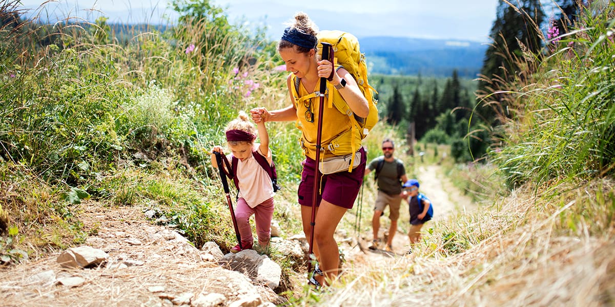 Family on a hike while they enjoy their holiday