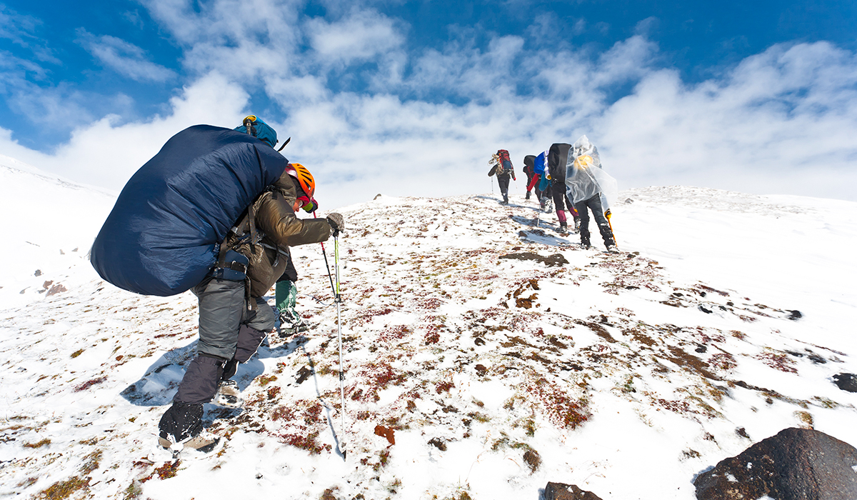 Hiking up a snowy mountain