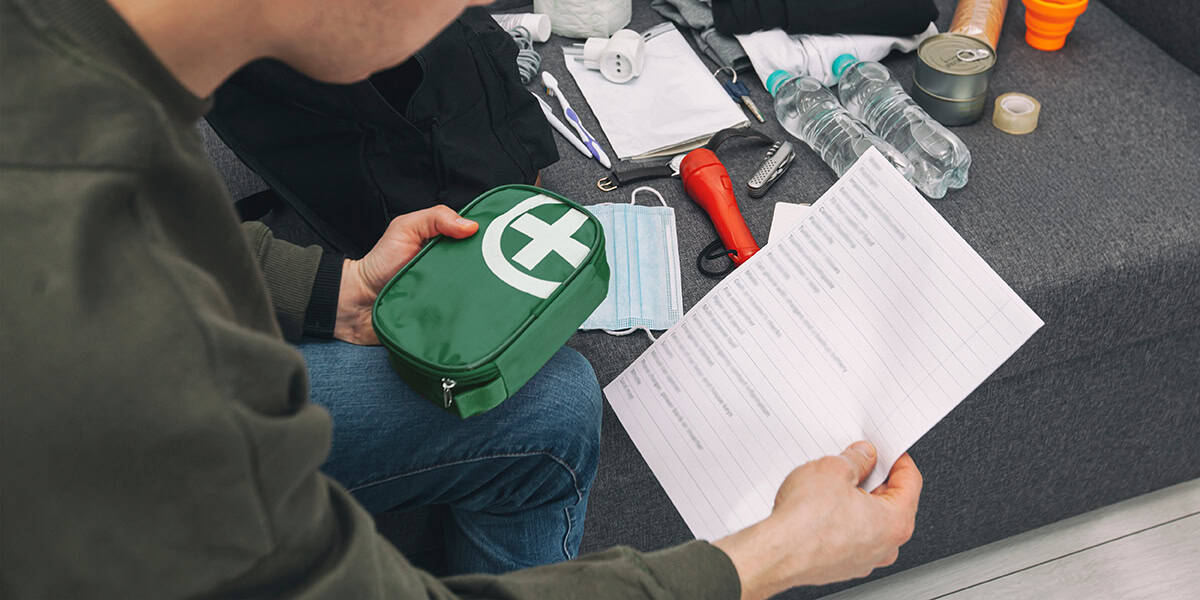 A man checking the contents of his first aid kit