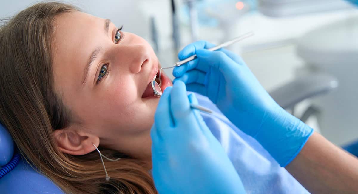 An image of nitrile gloves being used by a dentist