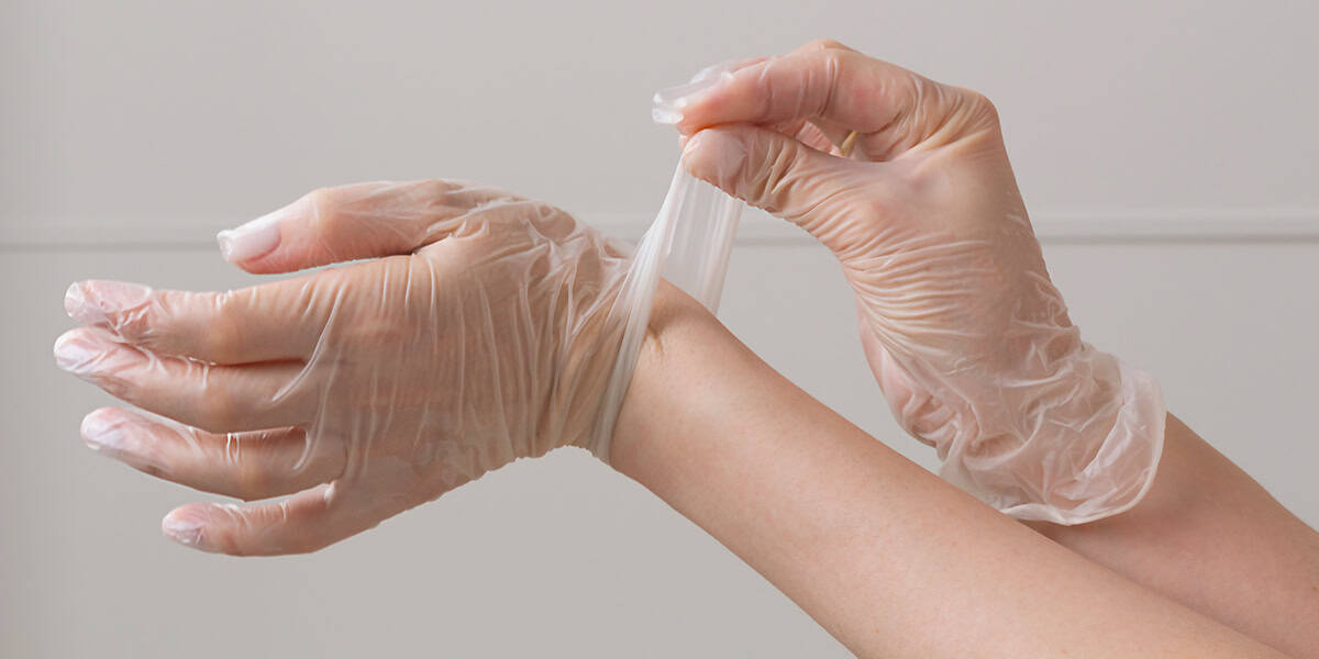 An image of vinyl gloves being used