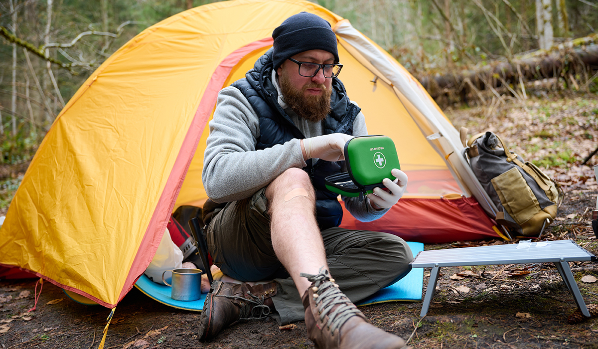 Someone camping with a first aid kit