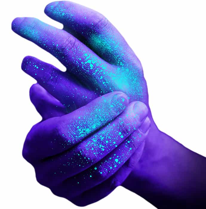 Hands under UV light are lit up with germs and microorganisms, showing how colds and viruses are spread.