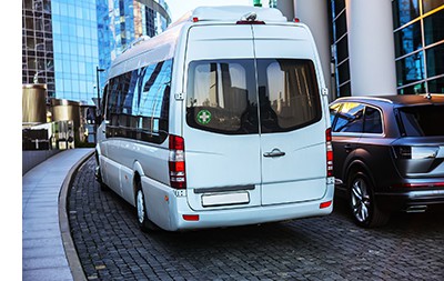 A minibus PCV taxi drives carefully down a cobbled city street – all public service vehicles require first aid kits