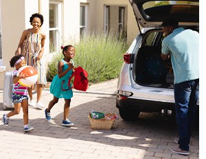 A responsible family packs a first aid kit into their car for a beach trip, making sure everyone is safe 