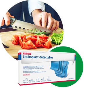 A person chops vegetables in a professional kitchen next to a box of Leukoplast detectable – visual and metal detectable plasters